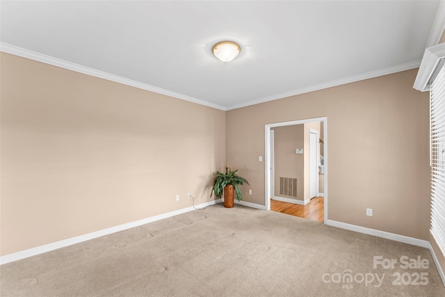 carpeted empty room featuring ornamental molding