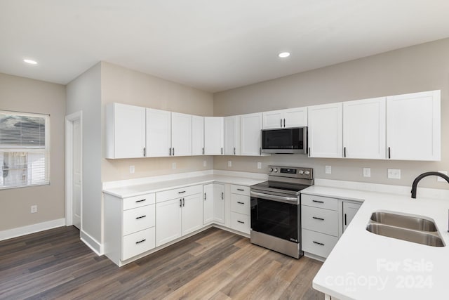 kitchen featuring white cabinets, dark hardwood / wood-style floors, sink, and stainless steel appliances