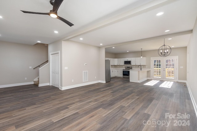 unfurnished living room with french doors, ceiling fan with notable chandelier, sink, dark hardwood / wood-style floors, and beamed ceiling