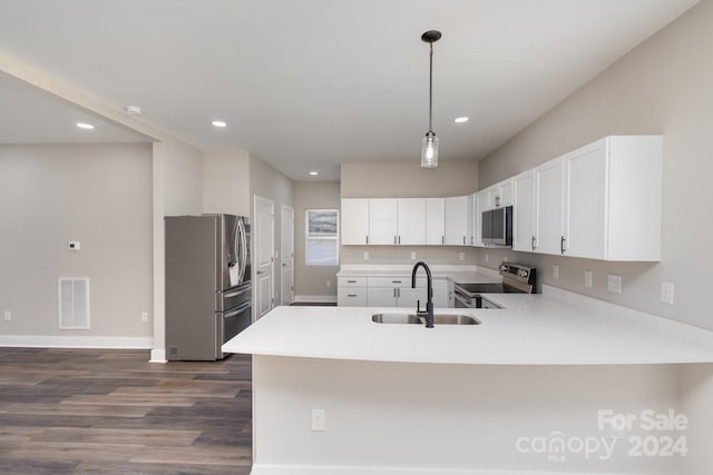 kitchen featuring kitchen peninsula, white cabinetry, sink, and stainless steel appliances