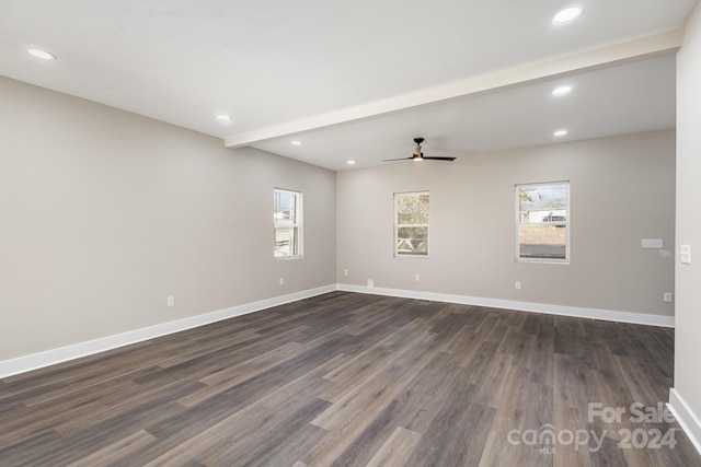 empty room with beamed ceiling, ceiling fan, and dark wood-type flooring