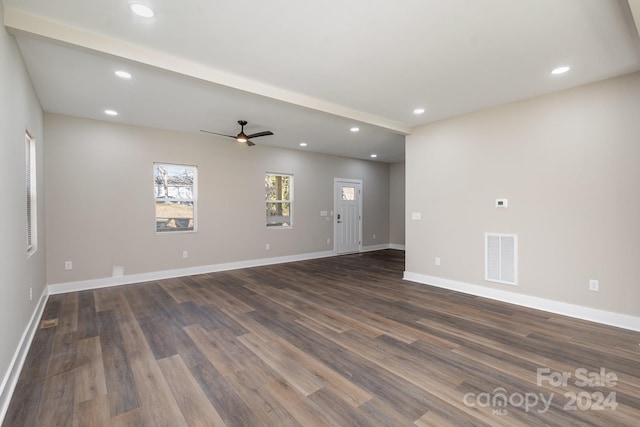 spare room featuring ceiling fan and dark wood-type flooring