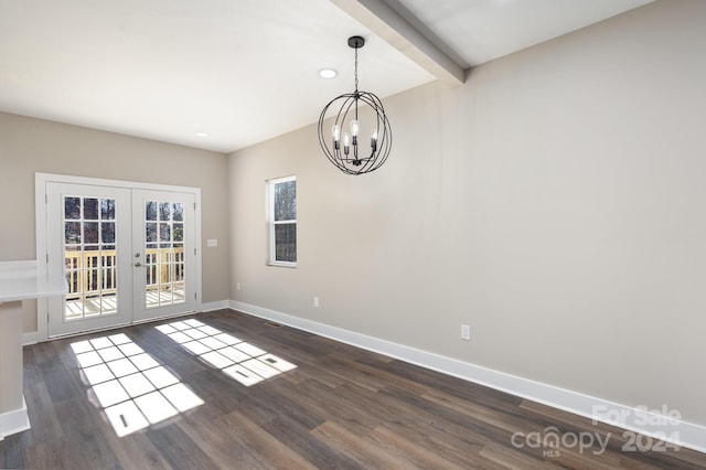 unfurnished room with beam ceiling, an inviting chandelier, dark wood-type flooring, and french doors