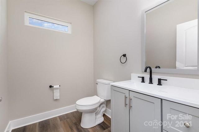 bathroom featuring vanity, toilet, and wood-type flooring