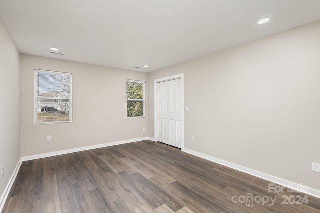 spare room with dark hardwood / wood-style flooring