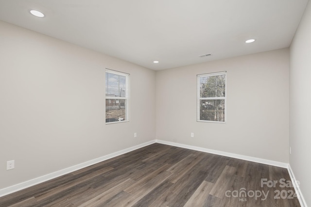 empty room featuring dark hardwood / wood-style flooring