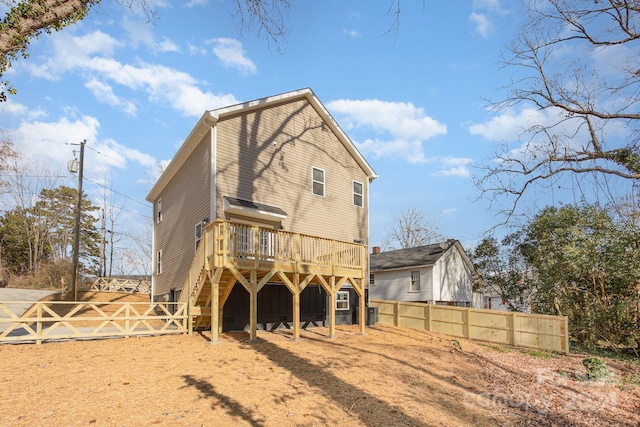 rear view of house with a wooden deck