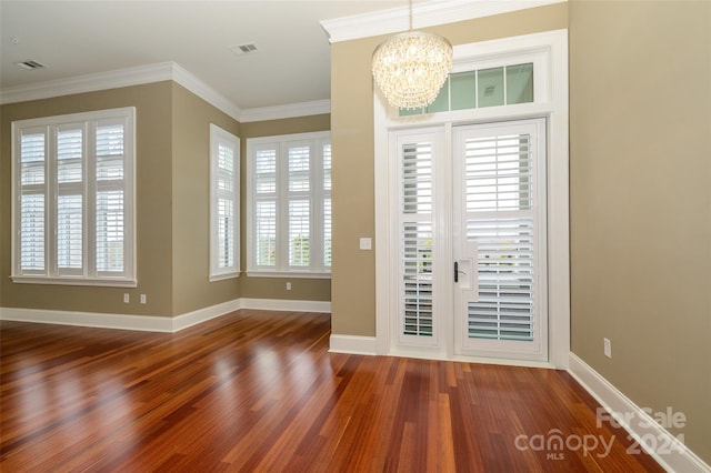 interior space with wood-type flooring, crown molding, and a notable chandelier