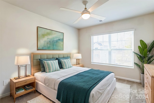 bedroom featuring ceiling fan and light carpet