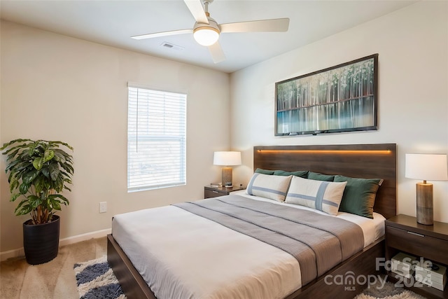 bedroom with ceiling fan and light carpet