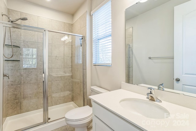 bathroom with vanity, toilet, and walk in shower