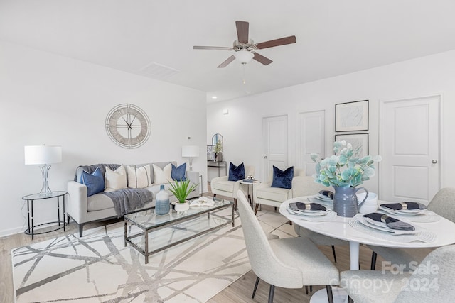 living room featuring ceiling fan and light hardwood / wood-style floors