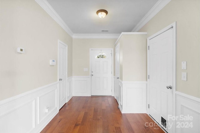 doorway to outside with crown molding and dark hardwood / wood-style flooring