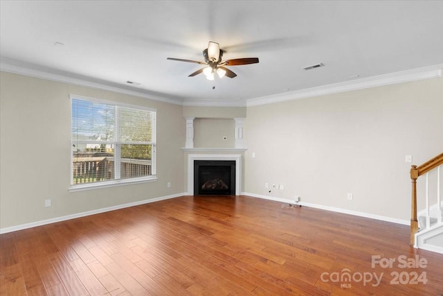 unfurnished living room with hardwood / wood-style floors, ceiling fan, and crown molding