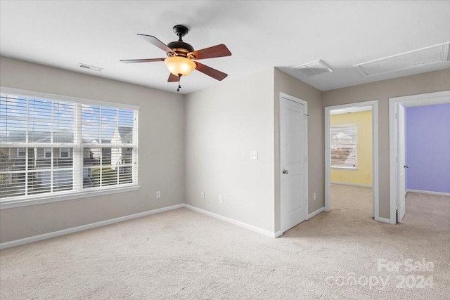 carpeted spare room featuring ceiling fan