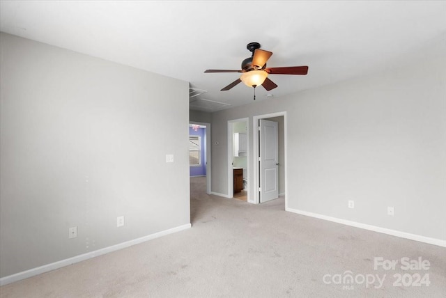 carpeted empty room featuring ceiling fan