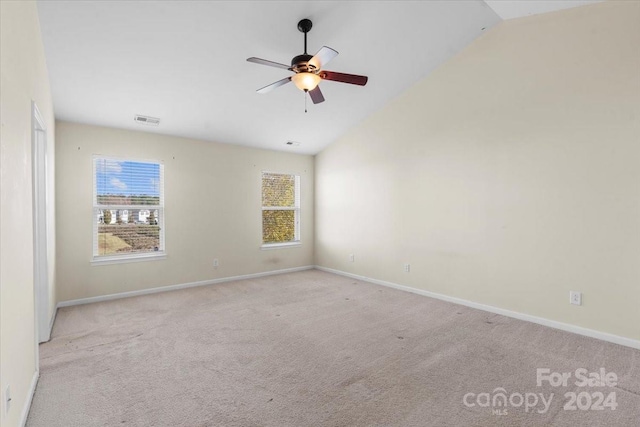 unfurnished room featuring ceiling fan, lofted ceiling, and light carpet