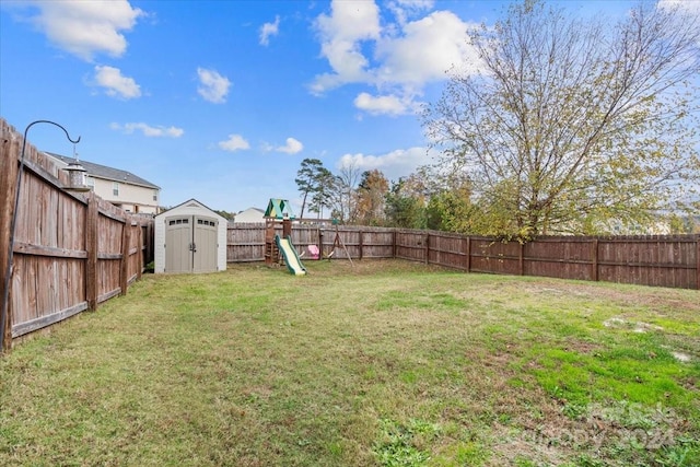 view of yard with a playground and a storage unit