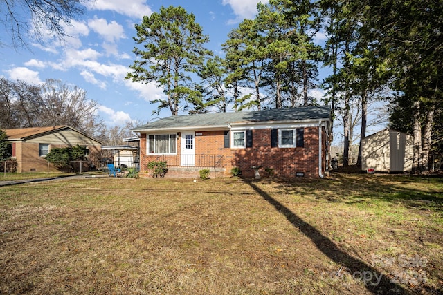 single story home with a front yard and a storage shed