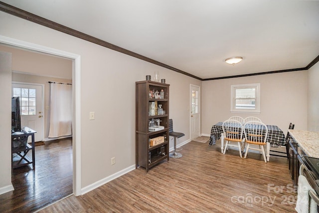 dining area featuring ornamental molding and hardwood / wood-style flooring