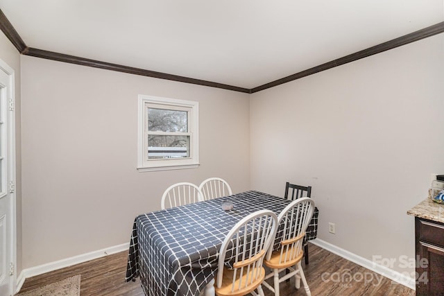 dining space featuring dark hardwood / wood-style flooring and crown molding