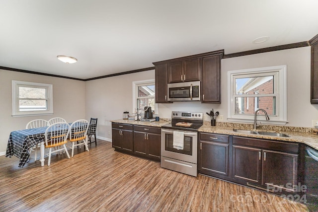 kitchen with plenty of natural light, light hardwood / wood-style floors, sink, and appliances with stainless steel finishes