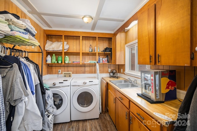 laundry area featuring cabinets, ornamental molding, dark wood-type flooring, sink, and separate washer and dryer