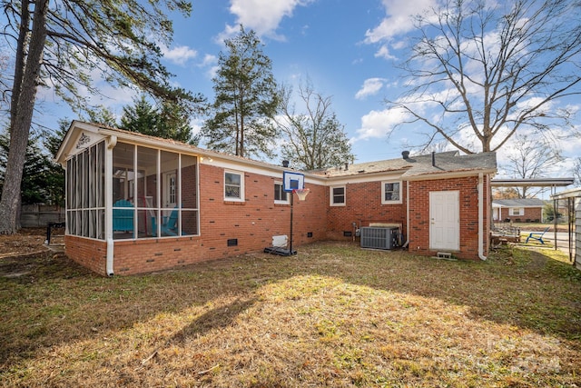 rear view of property featuring central AC unit, a lawn, and a sunroom