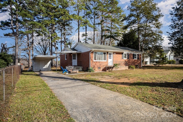 ranch-style house featuring a front yard and a carport