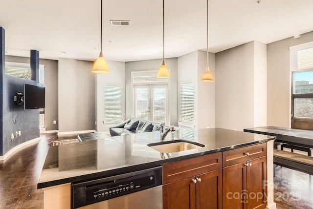 kitchen with stainless steel dishwasher, pendant lighting, a center island with sink, and sink