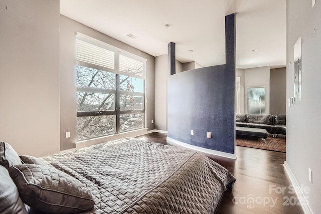 bedroom featuring dark hardwood / wood-style flooring