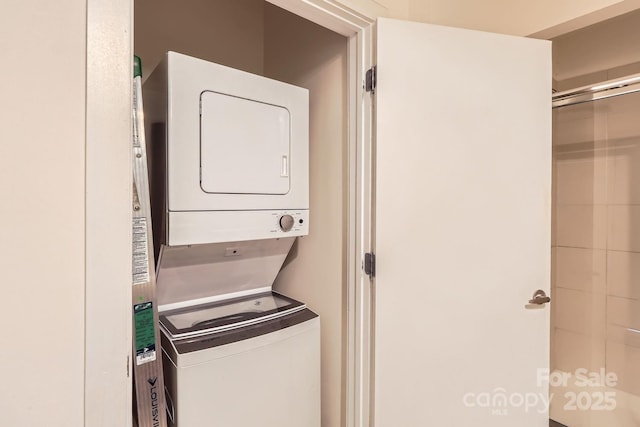 washroom featuring stacked washer / dryer