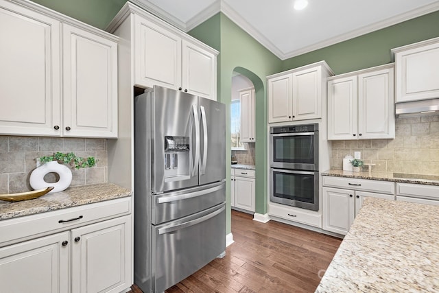 kitchen featuring white cabinets, appliances with stainless steel finishes, and tasteful backsplash