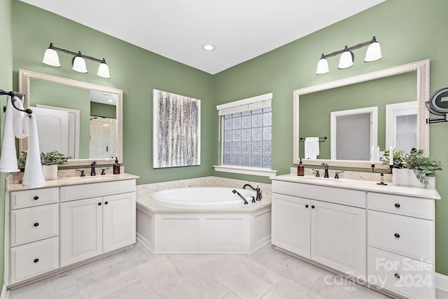 bathroom with tile patterned floors, vanity, and separate shower and tub