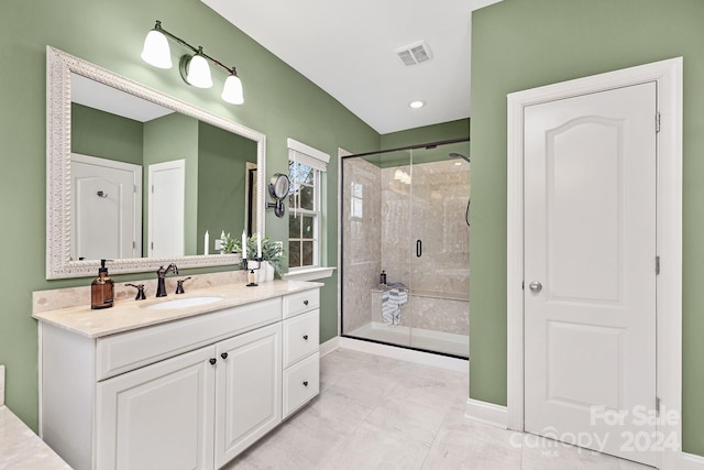 bathroom with tile patterned floors, vanity, and walk in shower