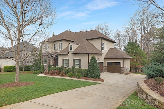 french country home with a garage and a front lawn