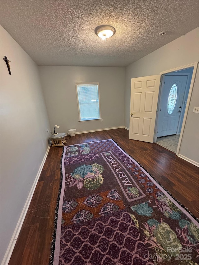 entrance foyer with a textured ceiling and wood-type flooring