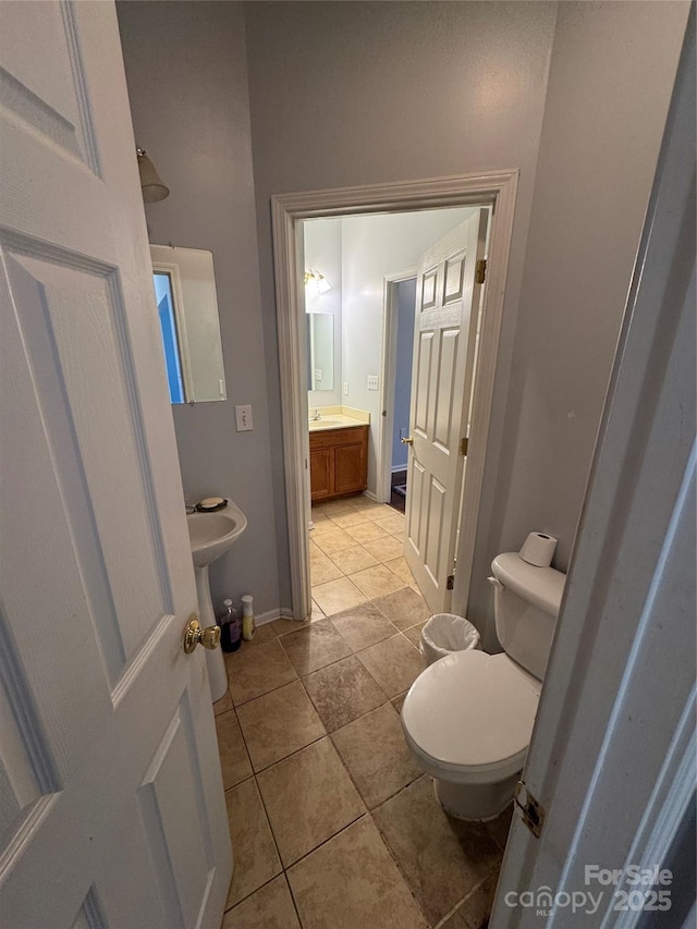 bathroom with vanity, toilet, and tile patterned floors