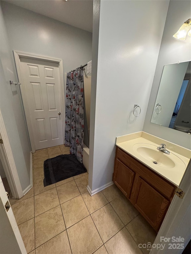 bathroom featuring shower / bath combo with shower curtain, tile patterned floors, and vanity