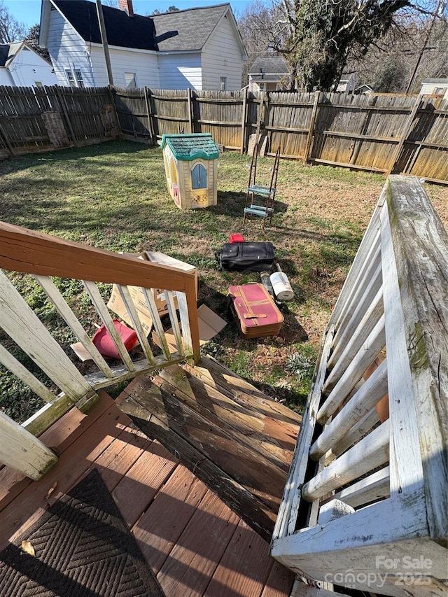 wooden deck featuring a lawn