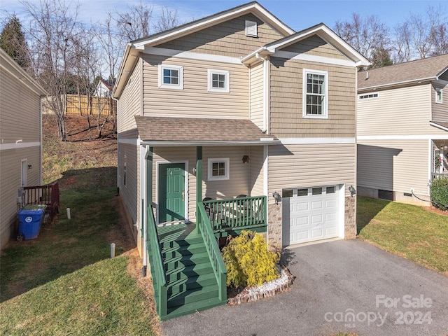 front facade with a front yard and a garage