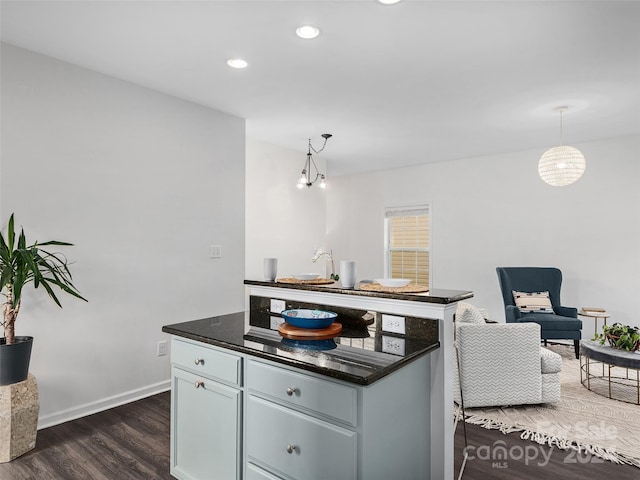 kitchen featuring pendant lighting, dark hardwood / wood-style flooring, and a kitchen island