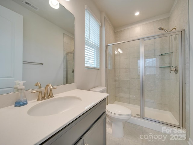 bathroom featuring tile patterned flooring, vanity, an enclosed shower, and toilet