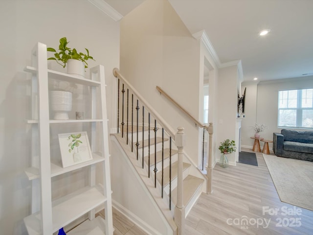 stairway featuring hardwood / wood-style flooring and crown molding