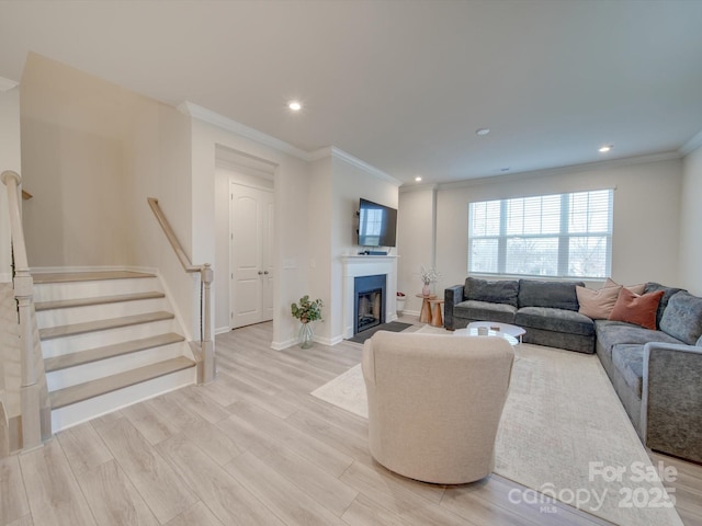 living room featuring light hardwood / wood-style flooring and crown molding