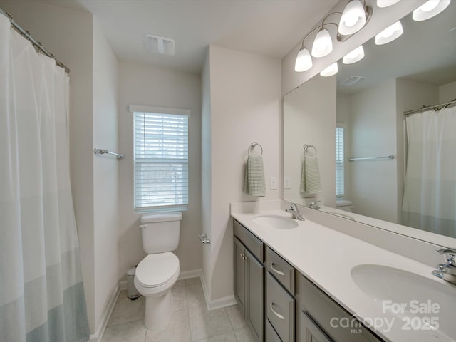 bathroom with tile patterned floors, vanity, and toilet