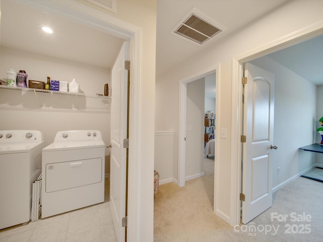 laundry room with light colored carpet and washer and clothes dryer