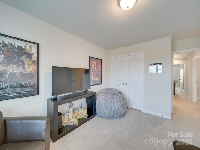 sitting room featuring light carpet