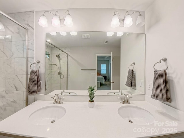 bathroom featuring vanity and a shower with shower door