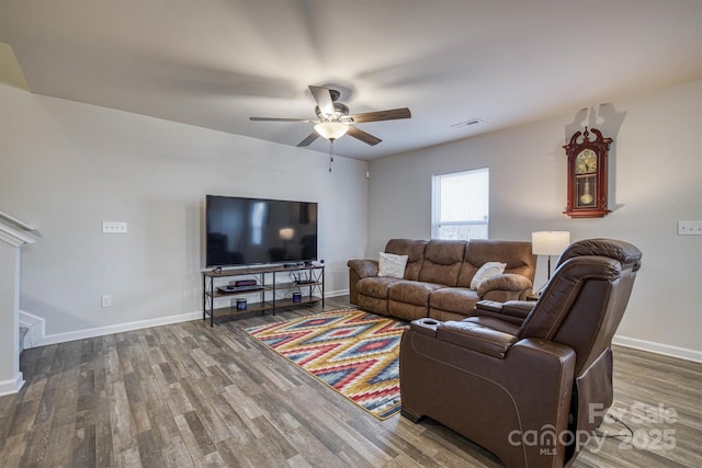 living room with wood-type flooring and ceiling fan